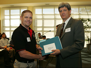 Poster presentation winner Justin Loop (left) and Associate Dean of Undergraduate Research Stuart Long (right)