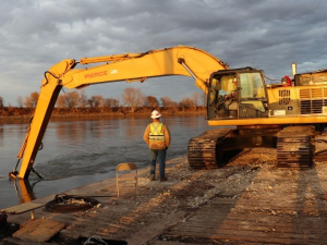The dredging planning optimization model (DPOM) algorithm weighs potential cost offsets when materials, such as sand, can be collected and repurposed. In this 2020 dredging, special equipment attached to the backhoe on the barge work boat redirected sand away from navigable areas. Photo credit: U.S. Army Corps of Engineers
